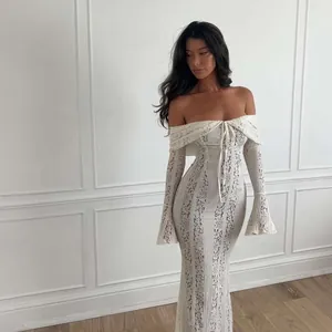 Full view of elegant white off-the-shoulder lace hollow maxi dress with flared bell sleeves