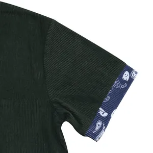 Close-up detail of heavy corduroy short sleeve shirt with paisley pattern on sleeve cuff