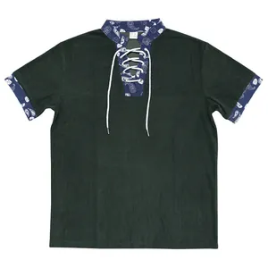 Detail view of dark green corduroy Henley shirt with paisley trim and lace-up neck.