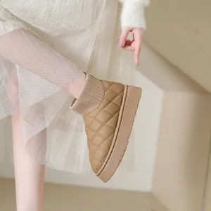 Close-up detail of women's quilted snow boots showing the platform sole and knitted cuff texture
