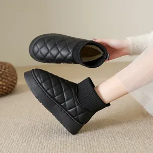 Detail shot showing the warm plush lining and quilted exterior of black platform snow boots
