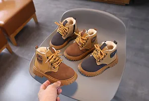 A collection of warm children's fleece-lined Martin boots in brown and gray colors.