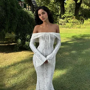 Detailed view of a white off-the-shoulder lace dress with a delicate front tie.