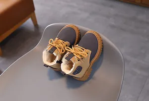 Detailed view of children's winter Martin boots with warm faux fur lining and anti-slip sole