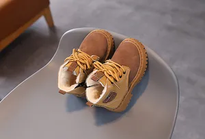 Close-up of children's warm Martin boots with soft fleece lining and suede finish