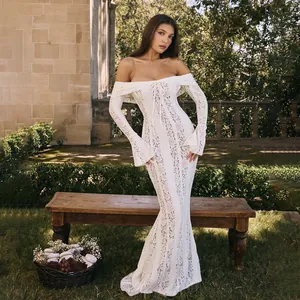 White lace off-shoulder long sleeve maxi dress shown in an elegant outdoor garden setting