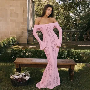 Elegant off-the-shoulder pink lace maxi dress with long sleeves in outdoor setting