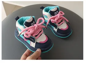 Detailed view of colorful high-top children's sneakers with vibrant pink chunky laces.