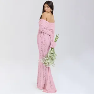 Elegant pink lace off-the-shoulder long sleeve maxi dress with sheer floral details.