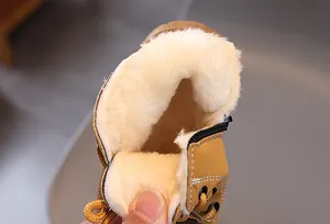 Close-up of warm white plush lining in yellow children's winter Martin boots detail.