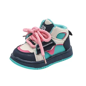 Close-up detail of high-top children's sneakers featuring vibrant dopamine colors and pink laces