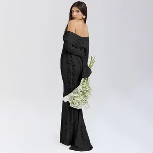 Detail view of a black off-shoulder lace maxi dress featuring an elegant openwork pattern