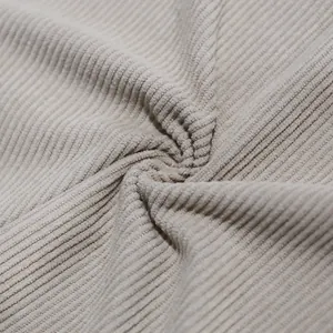 Macro view showing the soft texture and heavy ribbing of beige corduroy fabric detail