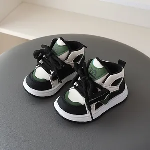 High-top children's sneakers in black white and green with stylish chunky laces