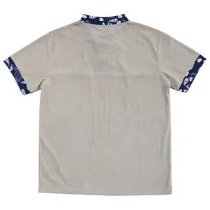 Back view detail of a khaki corduroy Henley shirt with navy paisley collar and cuffs.