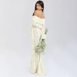 Elegant off-shoulder lace maxi dress with intricate hollow-out details and long sleeves