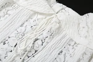 Detailed macro shot of white floral lace fabric with decorative drawstring on a dress