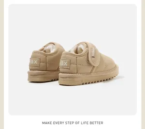 Detailed macro view of beige baby snow boots featuring a thick warm white fleece lining