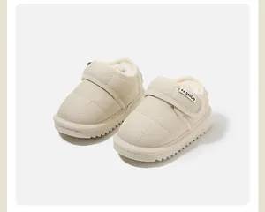 Detail view of beige baby snow boots featuring warm fleece lining and adjustable velcro strap.