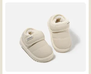 Detail view of beige baby snow boots with soft plush lining and Velcro strap
