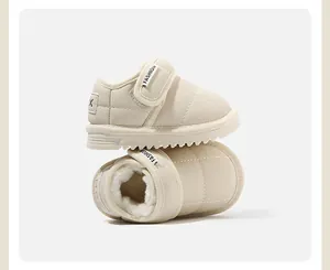 Detail view of beige baby snow boots showing soft fleece lining and velcro strap