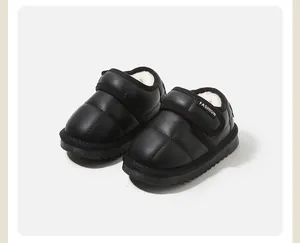Warm black baby snow boots featuring white fleece lining and adjustable Velcro straps for winter