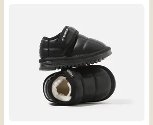 Detail of black toddler snow boots featuring warm fleece lining and Velcro strap