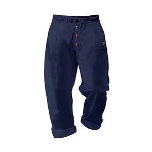 Detail view of navy blue men's linen pants with drawstring waist and button fly.