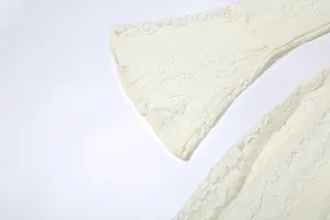 Close-up view showing the intricate texture of the white lace flared sleeve detail