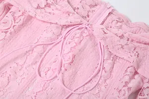Close-up of pink lace dress showing off-shoulder neckline and thin drawstring detail
