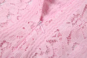 Macro detail showing the hidden zipper and floral lace pattern of a pink dress