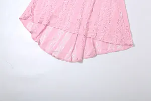 Detail view of the elegant pink lace hem on a slim-fit women's dress.