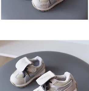 Close-up view of kids' sneakers in beige and grey with suede and leather details