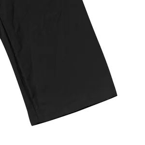 Detailed view of black linen pants cuff showing fabric texture and neat stitching