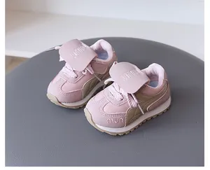 Detailed macro view of pink and olive children's sneakers with secure velcro strap