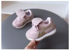 Pink and gold children's sporty sneakers with soft soles, velcro closure and cute design.