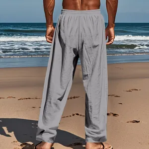 Back view detail of loose grey straight-leg casual linen trousers for men in beach setting