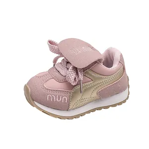 Close-up detail of stylish pink and gold toddler sneakers with a comfortable soft sole