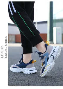 Side view detail of breathable blue and grey kids' mesh sneakers during outdoor play