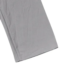 Close-up detail of grey linen pants hem featuring professional double-stitched finish.