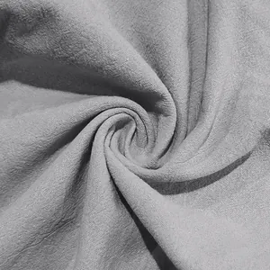 Macro detail view of light gray natural linen fabric texture for men's casual pants