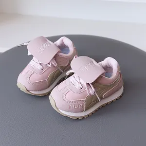 Pink and khaki toddler retro sneakers with soft soles for girls in a lifestyle setting