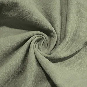 Macro detail of breathable sage green linen fabric texture for men's casual pants