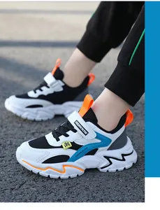 Detail view of breathable children's mesh sneakers in white, blue and orange colors
