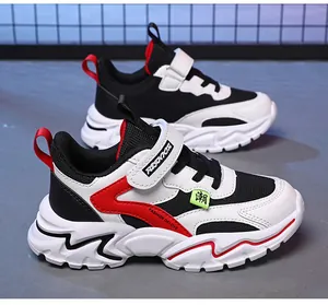 Kids' breathable mesh running shoes with non-slip soft soles in black and white.
