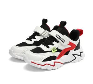 Detail of kids breathable mesh athletic shoes featuring velcro straps and red accents