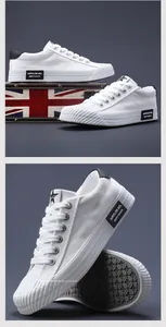 Detailed shot of white canvas sneakers showing textured rubber toe and side logo detail