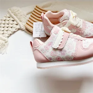 Detailaufnahme der rosa geblümten Mädchen-Sneaker mit Wellenschliff-Klettverschluss