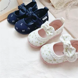 Cute floral and navy canvas baby walker shoes with large decorative bows for girls