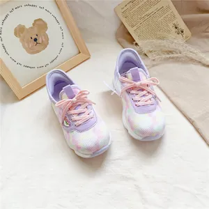 Detail view of breathable pastel mesh children's sneakers featuring pink laces.